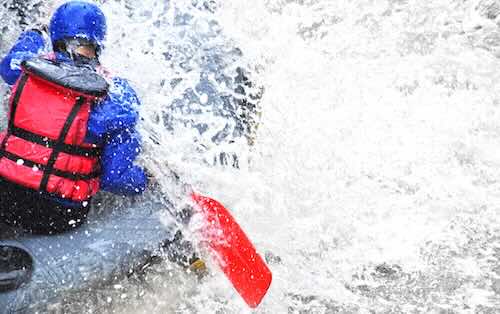 A person rafting through waves near Banff Alberta
