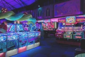 Dark & neon lit arcade bar interior