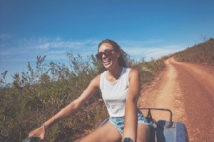 Girl on atv bike smiling and laughing