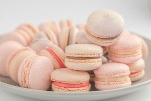 Pastel coloured macarons piled on plate