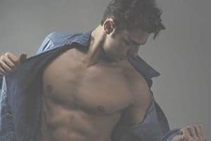 Sexy man taking off collared shirt