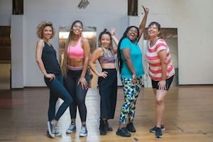 Friends smiling and posing in dance class