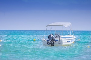 Small fishing boat stopped in crystal blue ocean waters