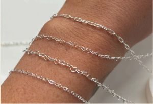 Permanent jewellery chains on woman's wrist