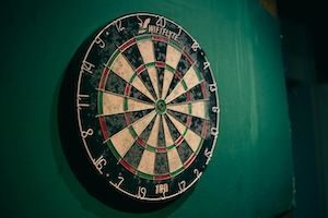 Close up of coloured dart board on green wall