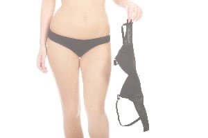Woman in underwear holding bra in one hand
