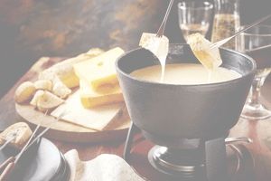 Fondue cheese pot and bread served on table