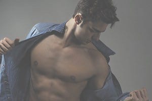 Sexy man with unbuttoned shirt revealing chiselled abs