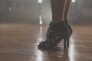Close up of woman in black scrappy high heels