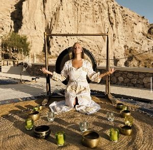 A woman doing sound healing with meditation