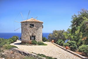 Stone building at end of pathway overlooking Greek oceans