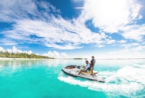 Two people on jet ski in crystal blue waters