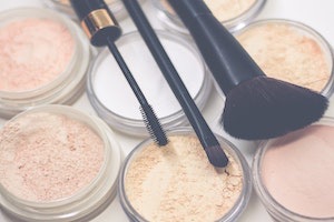 Close up of make up brushes, mascara & powders
