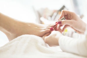 Close up of woman receiving pedicure treatment