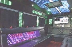 Inside of party bus with coloured lights.