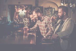 Group of guys cheersing beers together