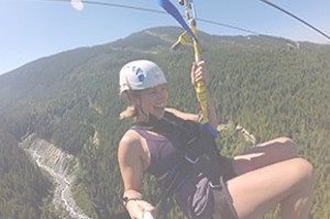 Close up of person on zip line in mountains