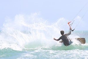 Man catching surf waves on wakeboard