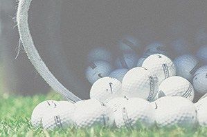 Golf balls stacked up on golf driving range