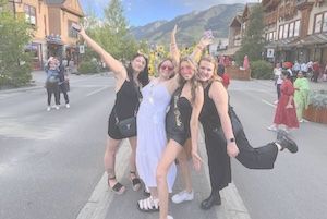 Group of girls posing on street while participating in scavenger hunt