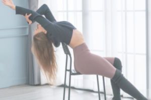 Girl in dancing studio stretching and posing