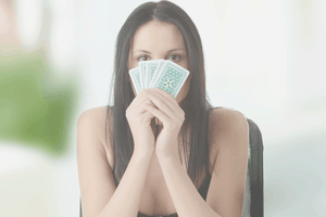 Girl holding poker cards in front of face