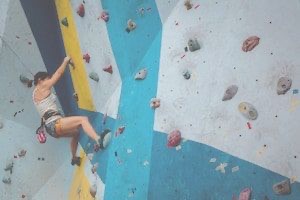 Person climbing indoor rock climbing course